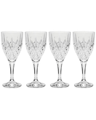 Set of four crystal champagne flutes on a white background