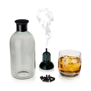 A smoked cocktail kit which includes a glass carafe, a glass with ice and liquid, a glass smoking stand, silicone stopper, and smoking pellets.