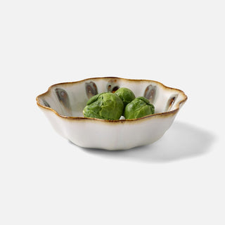 Small ceramic bowl with a decorative rim on a white background