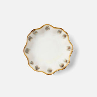 Decorative plate with gold rim and white pattern on a white background