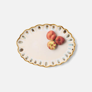 An oval ceramic serving platter with a scalloped rim, featuring a gold-trimmed edge, blue speckled accents, and three peaches placed on its surface, set against a plain light gray background.