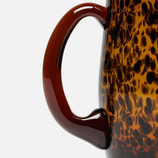 Tortoiseshell-patterned mug with a brown handle 