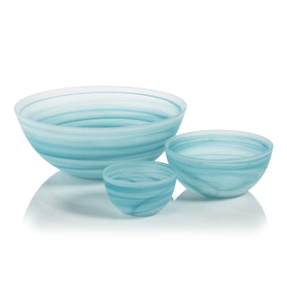 Set of three light blue glass bowls on a white background