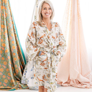  This cream robe with an orange, green, and blue floral and bird print is the perfect light robe for all seasons. 