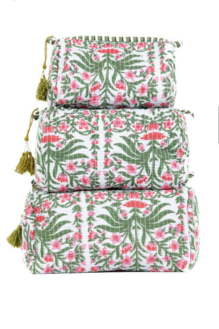Set of three floral-patterned bags with tassels on a white background