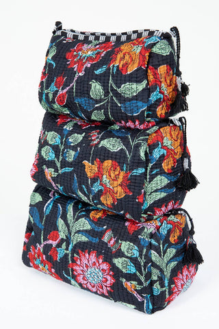 Stack of three floral-patterned bags on a white background