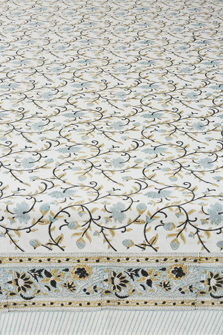 Close-up of a block print floral patterned tablecloth with stripe border