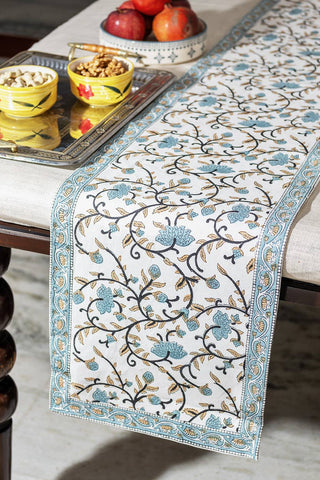Decorative hand block print table runner with floral pattern on a table