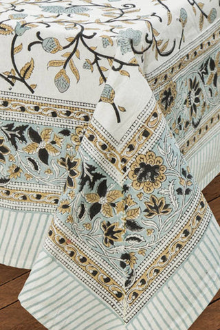 Decorative tablecloth with floral and stripe patterns on a wooden surface