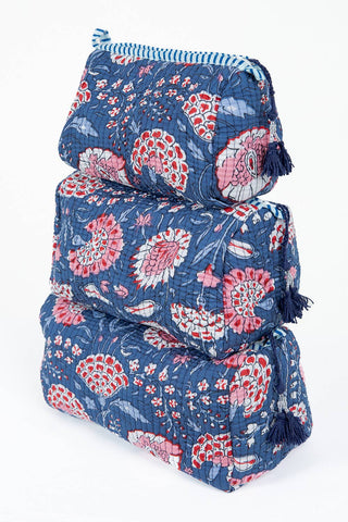 Set of three floral-patterned luggage sets stacked on a white background