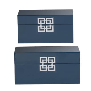Two navy blue boxes with a white geometric pattern on a white background