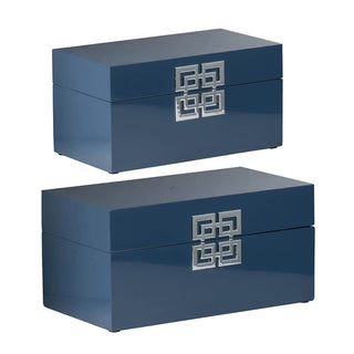 Two blue boxes with silver geometric patterns on a white background