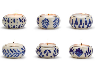 A collection of Chinoiserie tealight candleholders with blue and white floral patterns, each holding a small tealight candle.