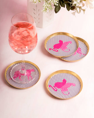 Set of coasters with pink jaguar design on striped background, placed around a glass of pink drink.