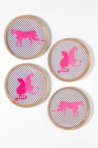 Four round coasters with light wood rims, featuring pink animal silhouettes on a white and gray striped background, arranged on a white surface.