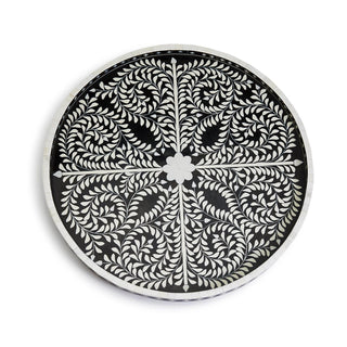 A round black and white decorative serving tray with a leafy mosaic pattern can be used as a tray or on a stand as a table