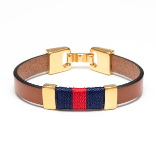 Bracelet with gold clasp, brown leather strap, and red and blue woven section on a white background
