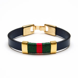Bracelet with gold clasp, green and red striped section, and navy band on a white background