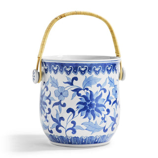 A blue and white Asian-style porcelain ice bucket with a woven cane basket handle.