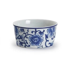A small white ceramic bowl decorated with a classic blue floral and vine pattern, shown against a plain white background.