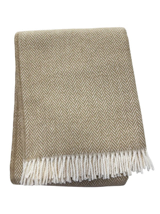 Beige and white herringbone patterned throw blanket with fringes on a white background