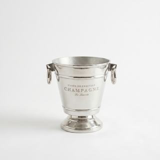 A polished silver champagne bucket with side handles and engraved text reading 'Cuvée de Prestige Champagne La Tourette' on a clean white background.