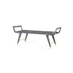 A black bench with a cane seat, made from oak, featuring brass sabots.