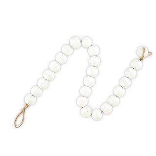 White beaded strand with closure on a white background