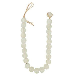 Strand of white glass beads on a white background