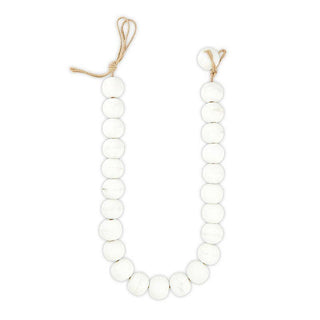 White beads with a string on a white background