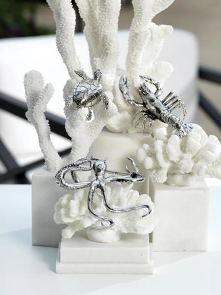 Decorative items including a turtle, lobster, and octopus on white coral