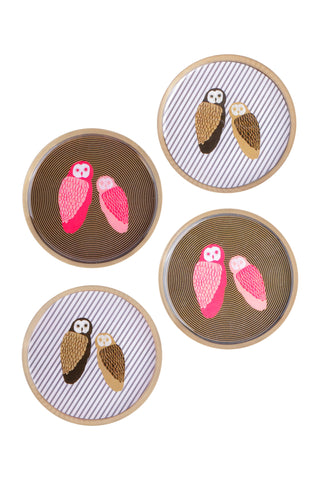 Four round decorative coasters with a natural wood border, featuring embroidered owl designs in pink, brown, and white on a clean white background.