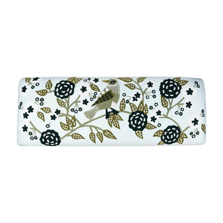 Decorative cylindrical pillow with floral and bird pattern on a white background