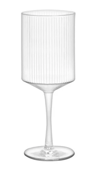 A clear fluted wine glass with a long stem perfect for outdoors