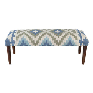 An upholstered bench with a geometric patterned fabric in shades of blue, green, and cream, supported by four dark brown wooden legs, shown against a plain white background.