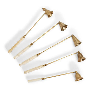 Set of five brass candle snuffers with bone and resin handles on a white background