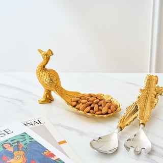 A gold peacock-shaped dish, designed for serving hors d'oeuvres or as a trinket tray.