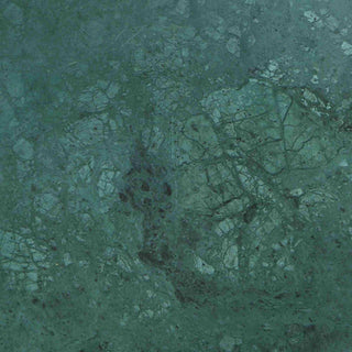 A close-up of a textured material or surface in muted teal-green tones with darker veining and speckling, filling the entire frame.