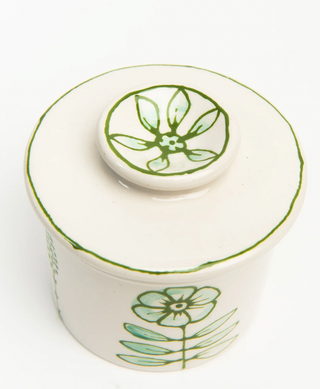 White ceramic butter crock with green floral designs hand painted. Each one is unique.