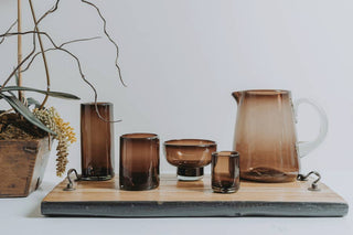 Set of handblown brown glassware including tumblers and a pitcher