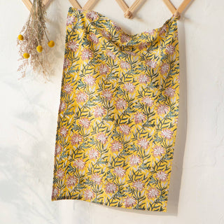 Floral-patterned fabric on a wooden hanger against a white background