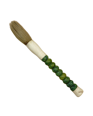 A traditional Chinese calligraphy brush with natural brown bristles, a cream-colored wooden ferrule, and a handle wrapped in green jade-like beads, isolated on a white background.
