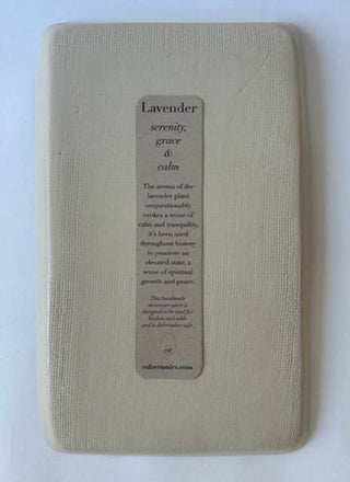 A square beige textured bath bomb or soap bar with a vertical brown paper label reading 'Lavender' and scent notes, photographed on a plain white background.