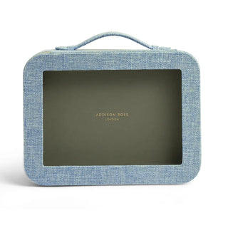 A light blue textured canvas cosmetic case with a top handle and a large dark olive window, featuring the Addison Ross London logo in gold on the front.