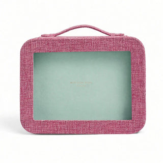 A rectangular pink textured fabric case with rounded corners, a top handle, and a clear window showing a mint green interior. The brand name 'ADDISON ROSS' is printed in gold foil in the center of the window.
