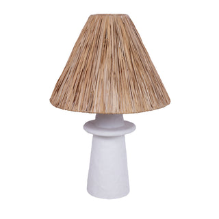 A white table lamp with a Mediterranean-inspired design, featuring a cement mix fiber base and a natural Raffia lampshade.