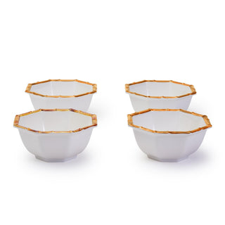 A set of four white octagonal bowls with bamboo colored rims are made of melamine for outdoor use