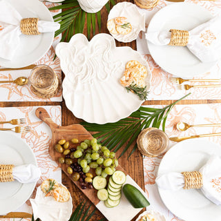 table set up with natural rattan napkin rings holding napkins