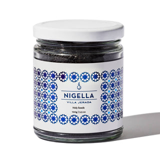 A jar of Nigella seeds with a blue and white decorative pattern on the label, indicating it is a product of Villa Jerada.