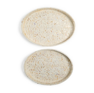 Decorative Mother of Pearl trays with intricate floral design on a ivory background